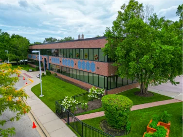 Exterior of an El Valor building surrounded by trees.