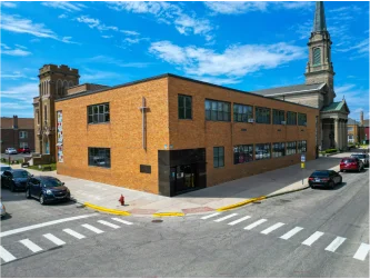 An El Valor building next to a church.