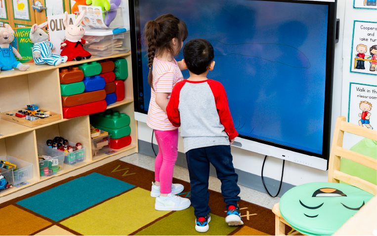 Young girl and boy using a smart board
