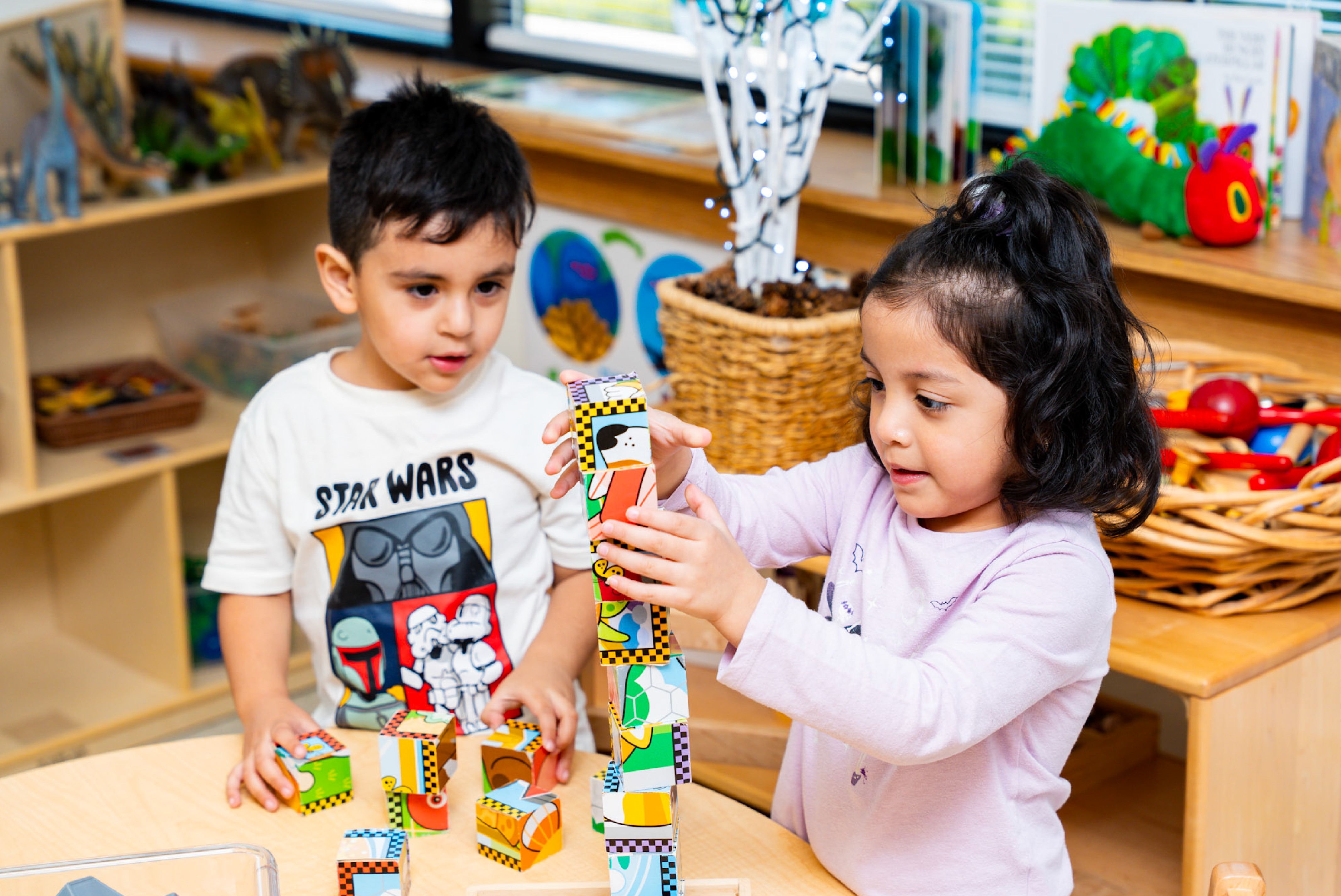 Little girl and boy playing with blocks in El Valor classroom
